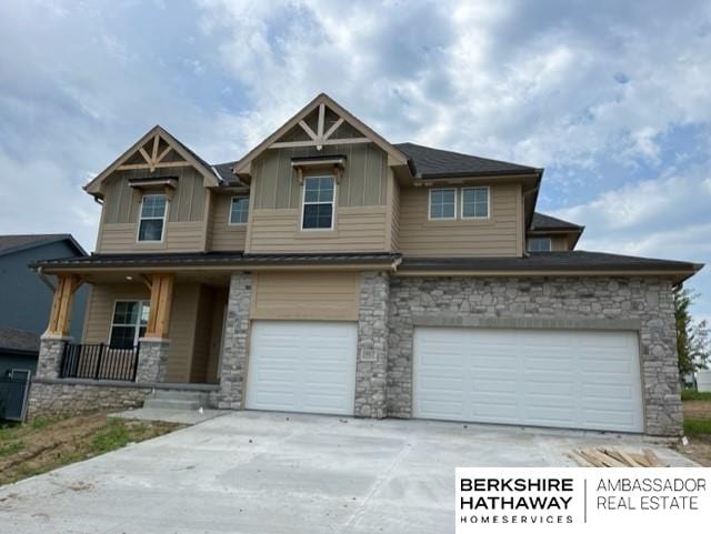 craftsman-style home featuring covered porch and a garage