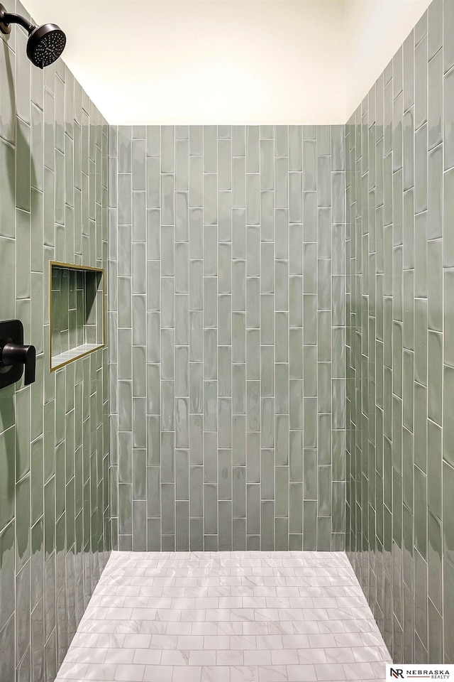 bathroom with a tile shower