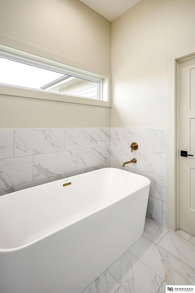 bathroom with tile walls and a washtub