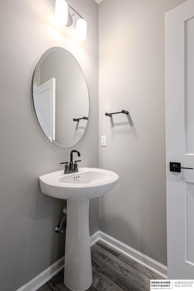 bathroom with hardwood / wood-style floors