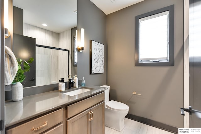 bathroom featuring tile floors, large vanity, and toilet