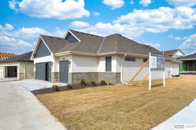 view of front of house with a front yard and a garage