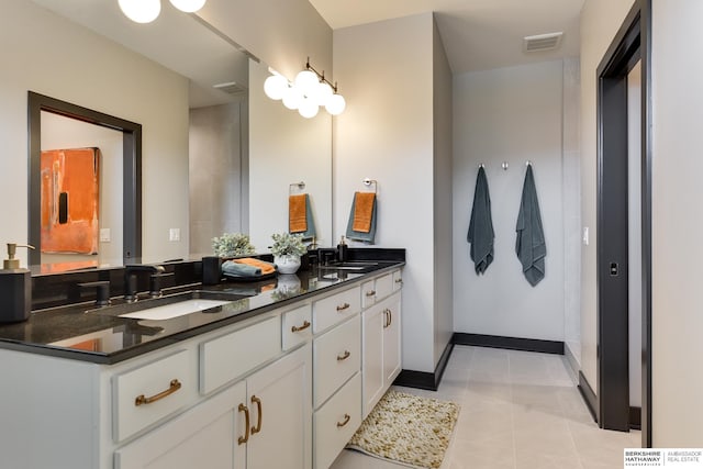 bathroom featuring tile flooring and dual vanity