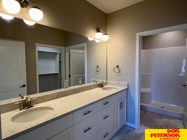 bathroom with walk in shower, dual bowl vanity, and tile floors