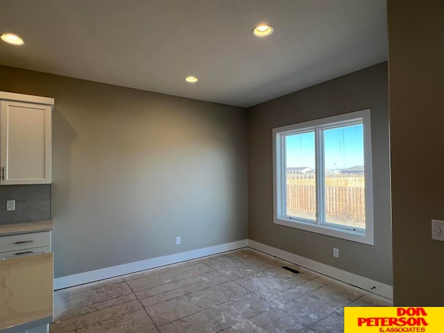 unfurnished dining area with light tile floors