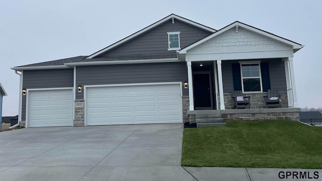 view of front of property featuring a garage and a front lawn