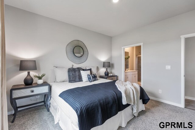 carpeted bedroom featuring ensuite bath