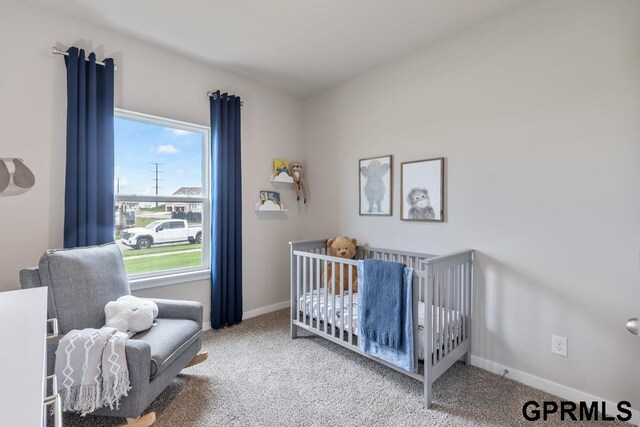 carpeted bedroom featuring a crib