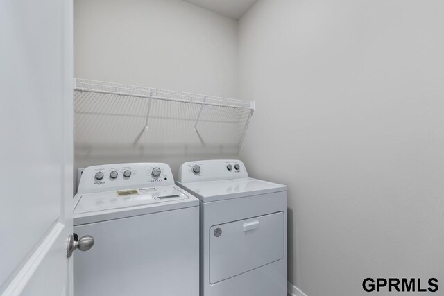 washroom with washing machine and clothes dryer