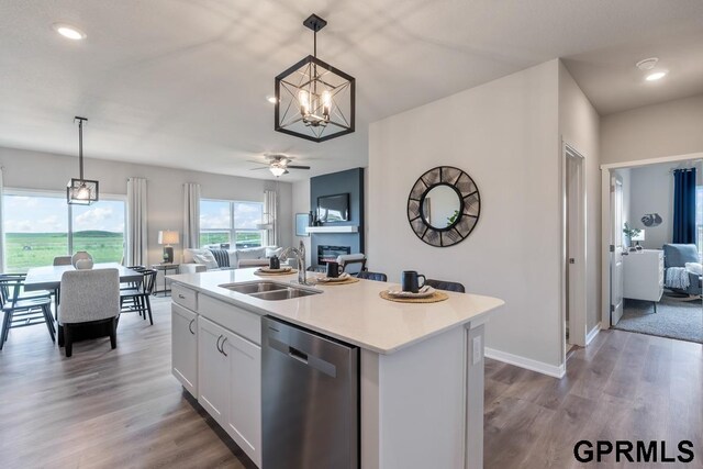 kitchen with dishwasher, white cabinetry, a kitchen island with sink, and pendant lighting