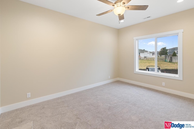 spare room featuring ceiling fan and light colored carpet