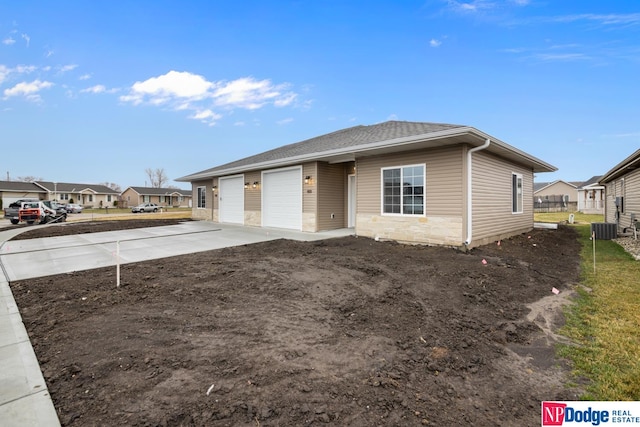 view of front of house featuring central air condition unit and a garage