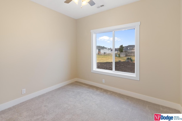 spare room with ceiling fan and light carpet