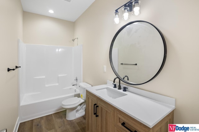 full bathroom featuring toilet, wood-type flooring, shower / bath combination, and vanity