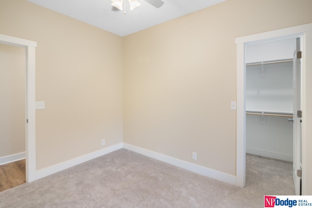 unfurnished bedroom with ceiling fan, a closet, and light colored carpet