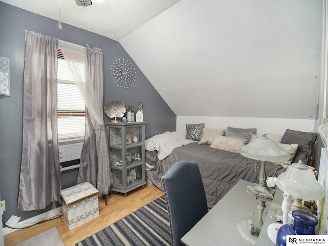 bedroom featuring vaulted ceiling and light hardwood / wood-style floors