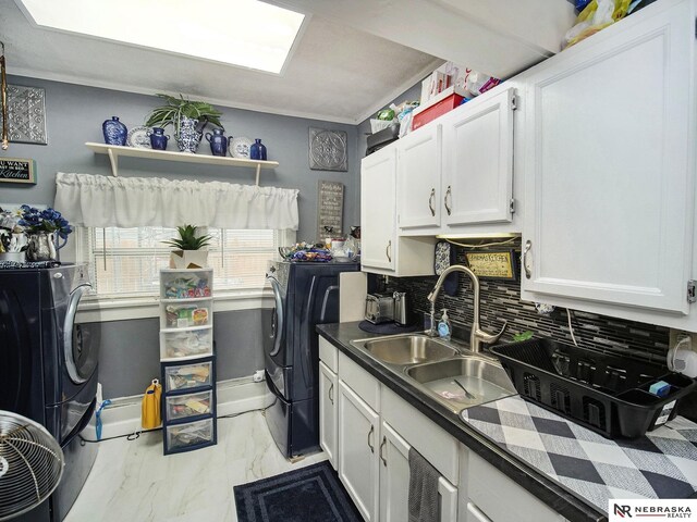 kitchen with white cabinetry, sink, backsplash, and light tile flooring