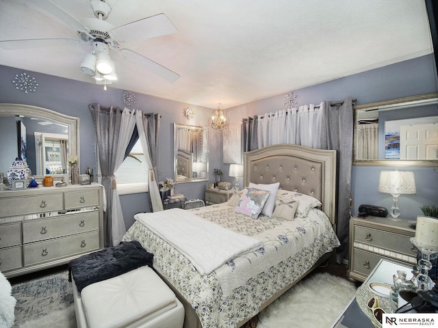 bedroom featuring carpet and ceiling fan with notable chandelier