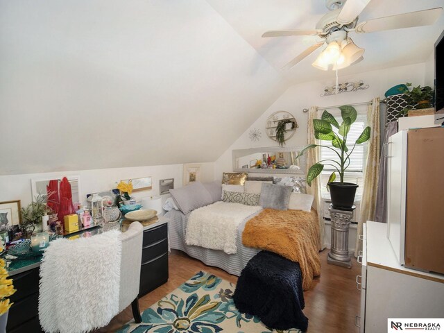 bedroom with vaulted ceiling, wood-type flooring, and ceiling fan