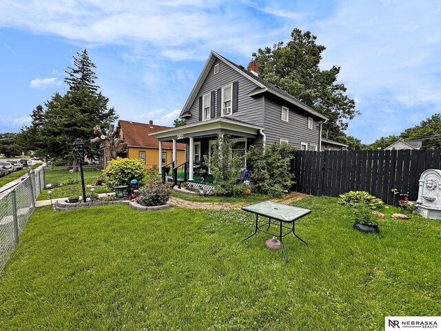 rear view of property featuring a yard