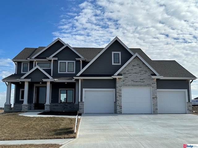 craftsman-style house featuring a porch and a garage