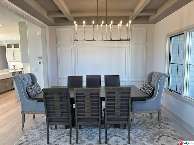 dining space featuring beam ceiling, plenty of natural light, light hardwood / wood-style flooring, and coffered ceiling