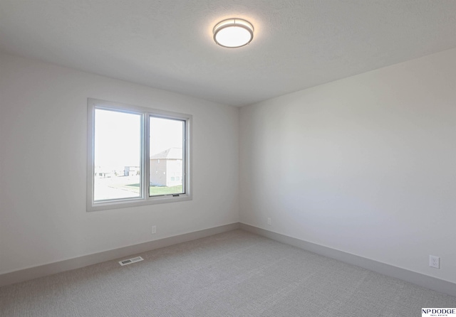 unfurnished room with carpet flooring