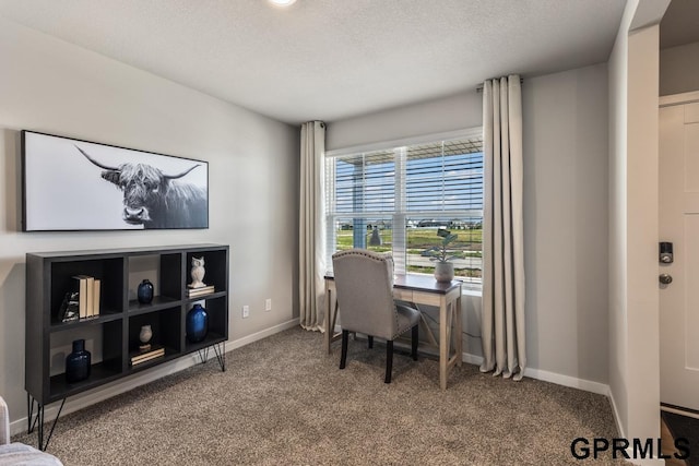 office area featuring a textured ceiling and dark colored carpet