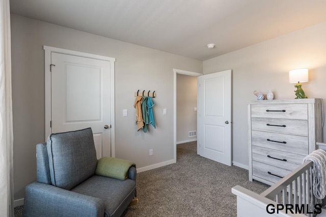 sitting room featuring dark carpet