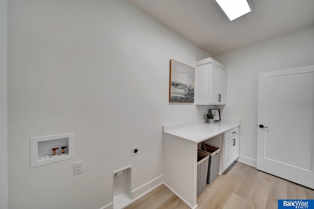 laundry area with hookup for a washing machine, hookup for an electric dryer, cabinets, and light hardwood / wood-style floors