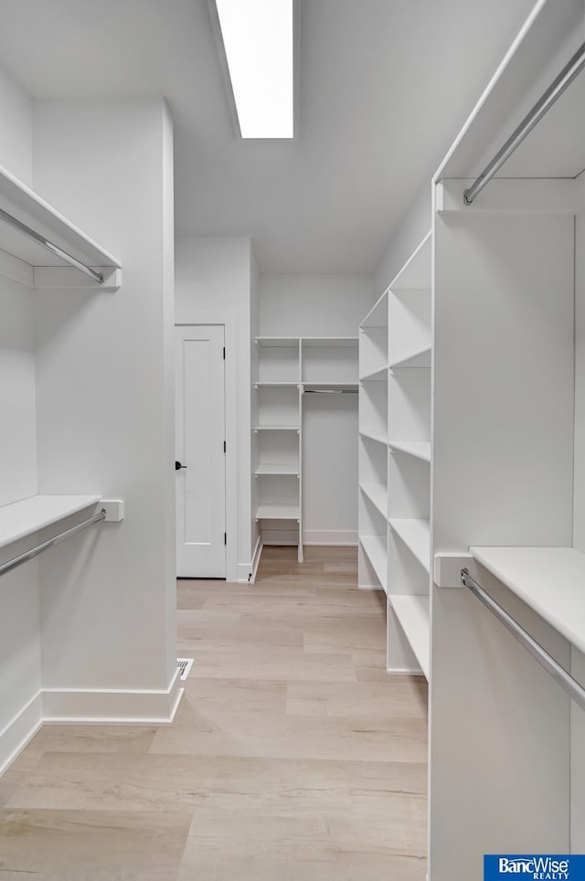 spacious closet with light wood-type flooring