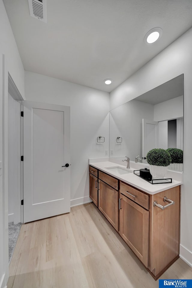 bathroom with vanity and hardwood / wood-style floors