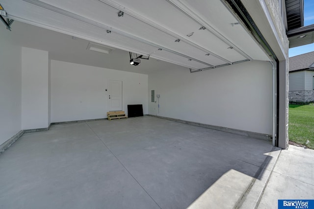 garage featuring electric panel and a garage door opener