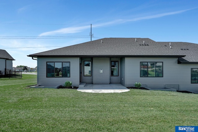 rear view of property with a yard and a patio area