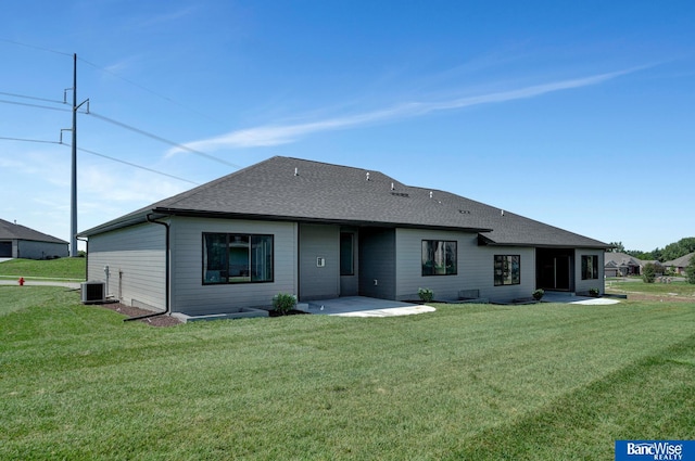 rear view of property with a patio, cooling unit, and a lawn