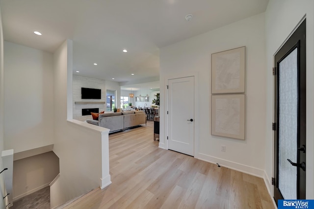 kitchen featuring a fireplace and light wood-type flooring