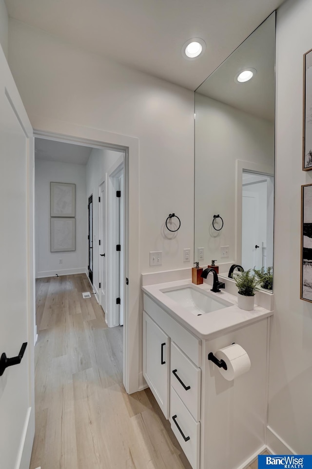 bathroom with vanity and hardwood / wood-style floors