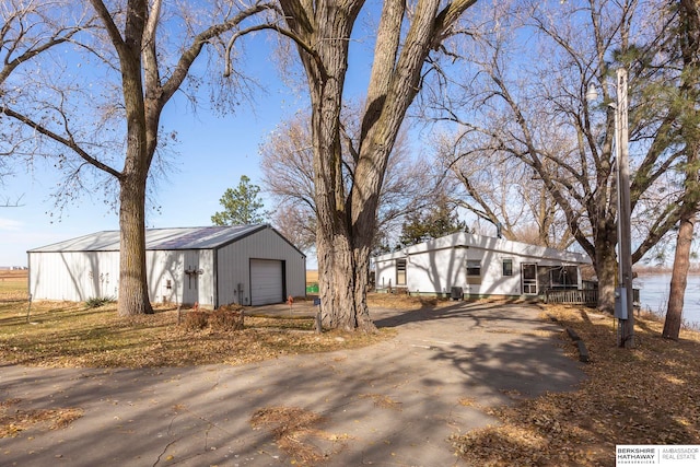 view of front facade featuring a garage and an outdoor structure