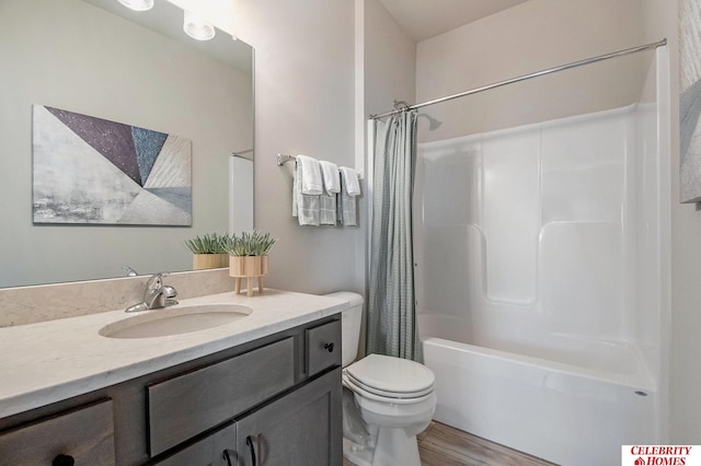 full bathroom featuring toilet, vanity, hardwood / wood-style flooring, and shower / tub combo with curtain