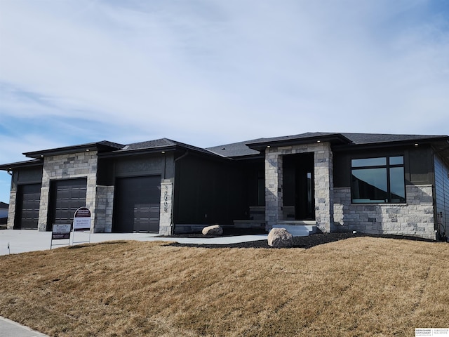 prairie-style home featuring a garage and a front yard