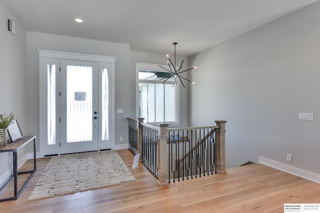 entryway with a chandelier and light hardwood / wood-style flooring