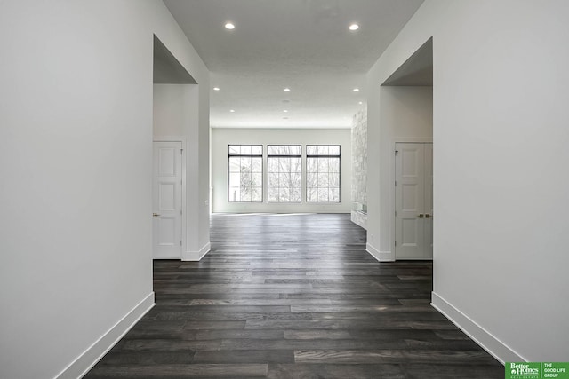 hall with dark wood-type flooring