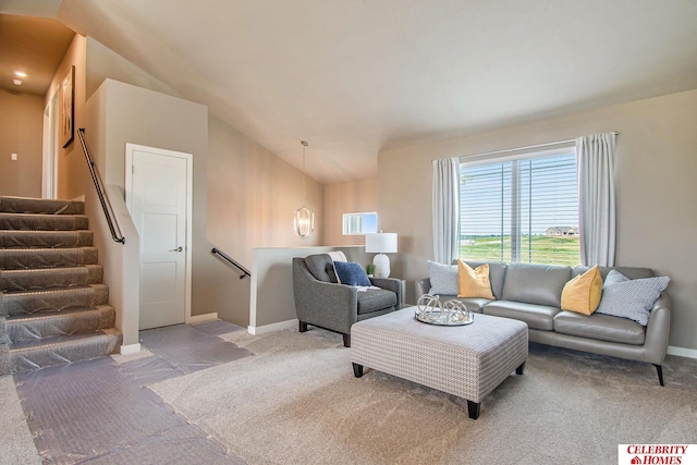 carpeted living room with lofted ceiling