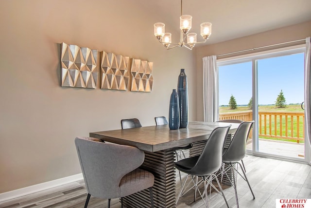 dining room with an inviting chandelier and light hardwood / wood-style floors