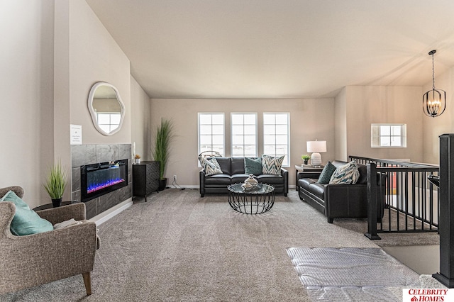 carpeted living room with a chandelier, plenty of natural light, and a tiled fireplace