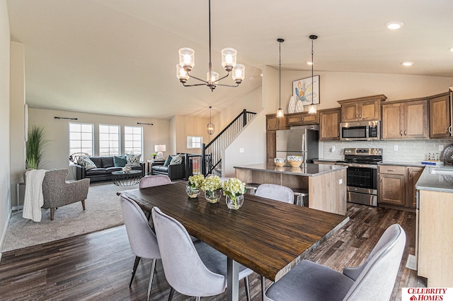 dining area featuring high vaulted ceiling, dark hardwood / wood-style flooring, and an inviting chandelier