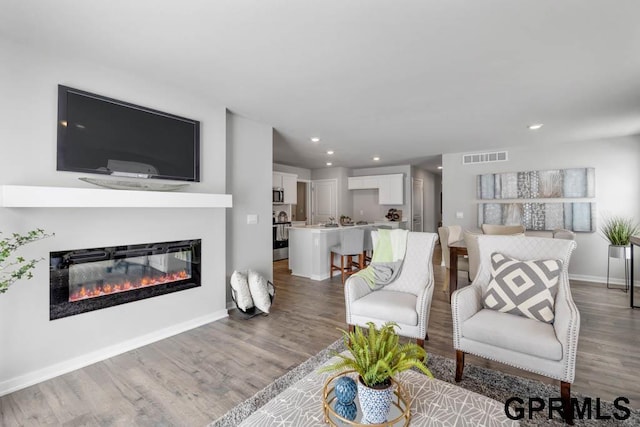 living room with light hardwood / wood-style flooring