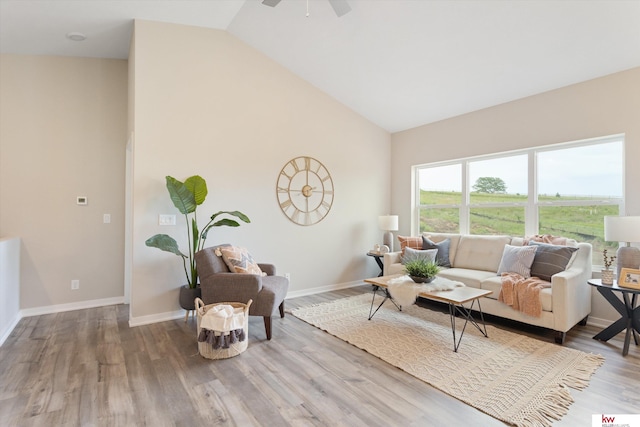 living room with high vaulted ceiling, ceiling fan, and hardwood / wood-style flooring