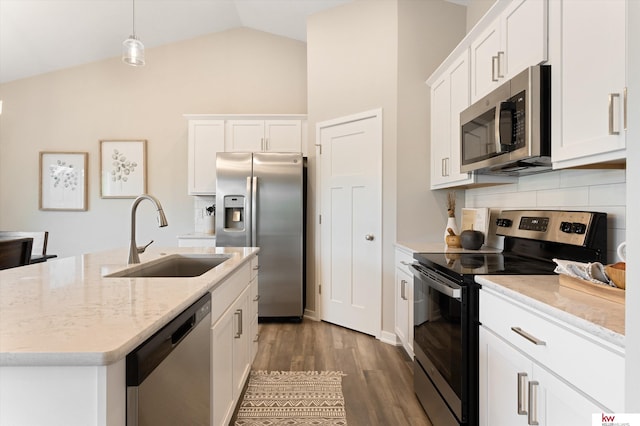 kitchen featuring appliances with stainless steel finishes, wood-type flooring, lofted ceiling, white cabinetry, and sink