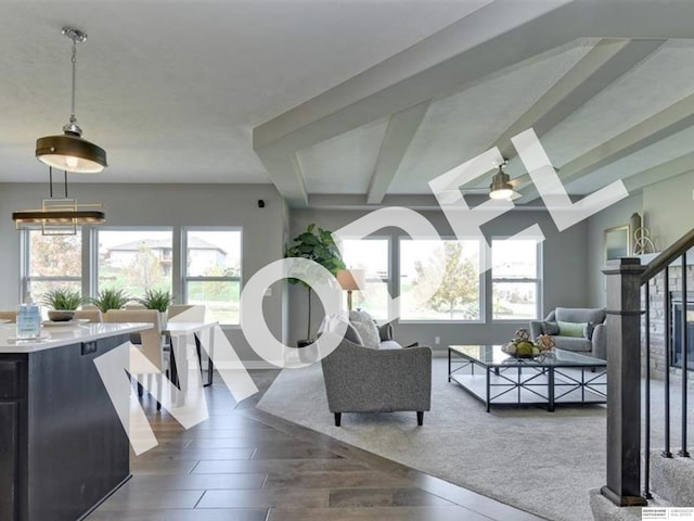 living room featuring hardwood / wood-style floors, beamed ceiling, and ceiling fan